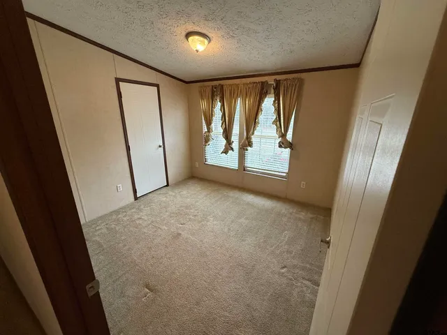 a bathroom with a granite countertop sink toilet and mirror