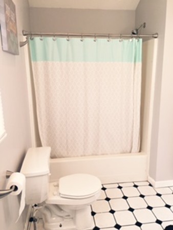 60 Valley Road Dracut, MA 01826 - Photo 11 of 15 a bathroom with a toilet and a shower curtain