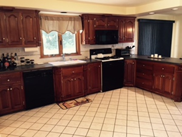 60 Valley Road Dracut, MA 01826 - Photo 2 of 15 a kitchen with a sink a stove and a microwave