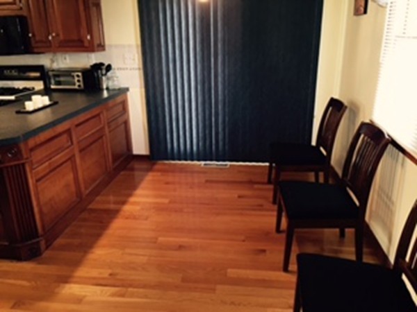 60 Valley Road Dracut, MA 01826 - Photo 4 of 15 a view of kitchen with cabinets and wooden floor