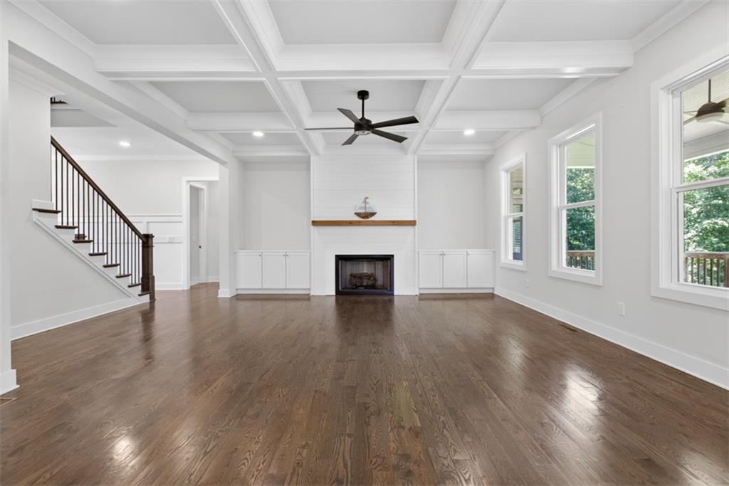 3528 North Bogan Road Buford, GA 30519 - Photo 7 of 79 a view of an empty room with wooden floor fireplace and a window