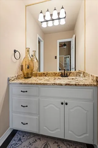 a bathroom with a sink vanity and mirror