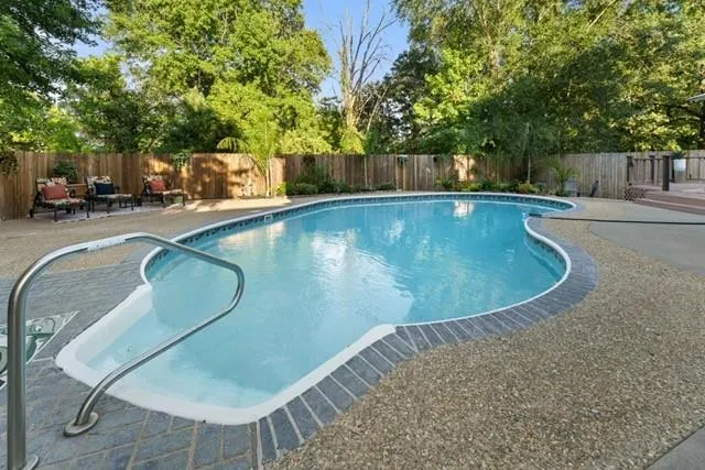 a view of a swimming pool with a patio