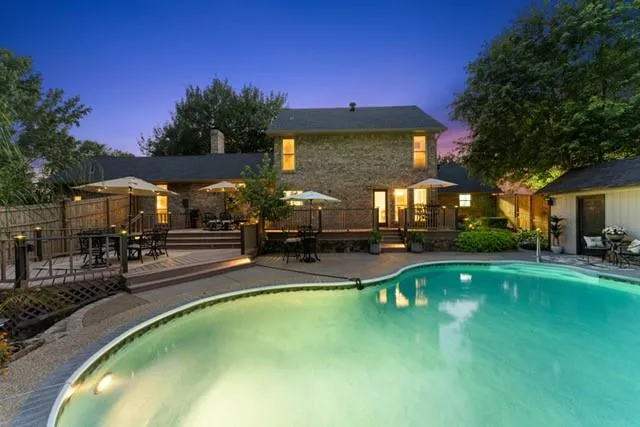 a swimming pool with outdoor seating and yard