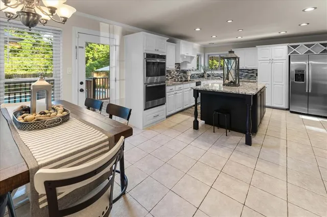 a kitchen with stainless steel appliances kitchen island granite countertop a sink and cabinets
