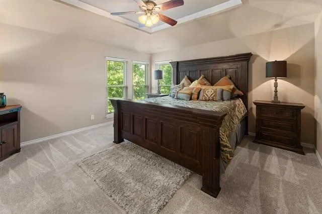a bed room with a bed and a ceiling fan
