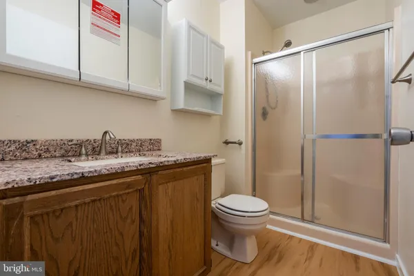 an empty room with chandelier fan and windows