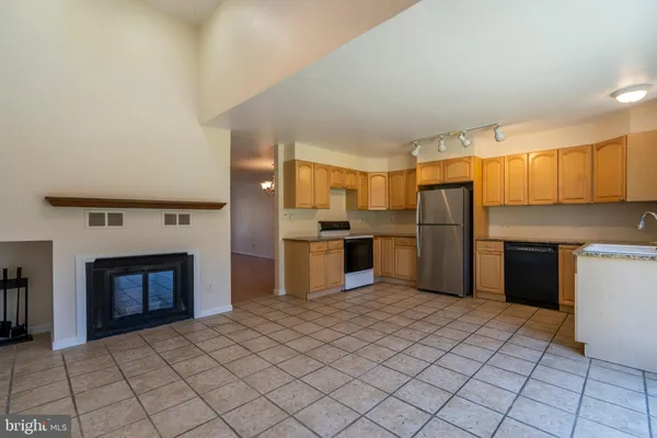 a kitchen with a refrigerator and a stove top oven