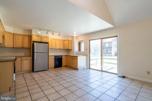 a kitchen with stainless steel appliances a refrigerator and a stove top oven
