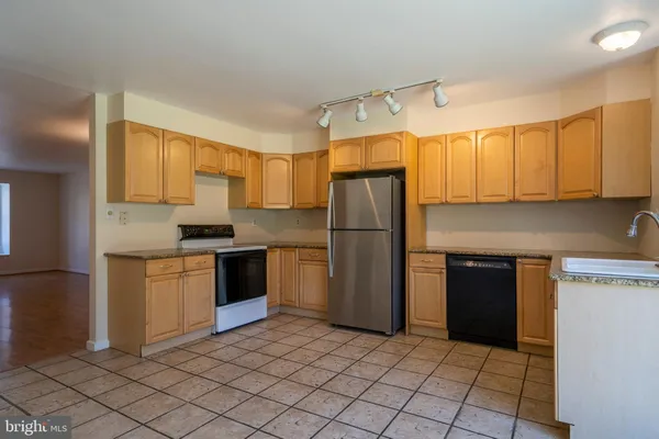 a kitchen with a refrigerator sink and microwave