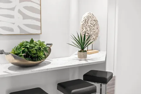 a kitchen with granite countertop white cabinets sink and white appliances