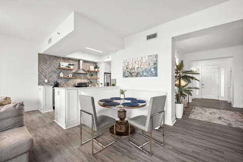 a living room with furniture a couch and a window