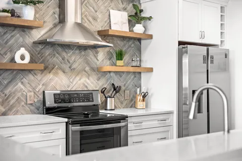 a kitchen with a stove and a refrigerator