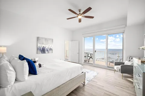 a bedroom with a large bed and a large window