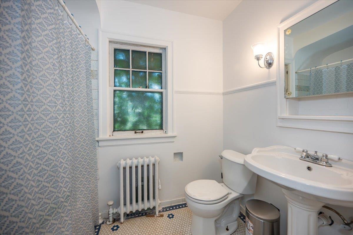 2202 Missouri Avenue Superior, WI 54880 - Photo 11 of 24 Full bathroom featuring radiator and a shower with shower curtain