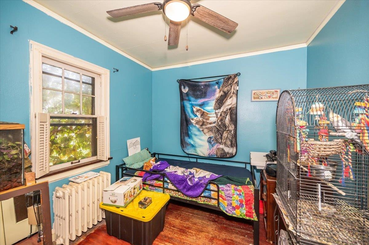 2202 Missouri Avenue Superior, WI 54880 - Photo 12 of 24 Bedroom with radiator, crown molding, dark wood-style flooring, and a ceiling fan