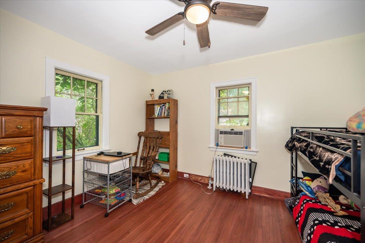 2202 Missouri Avenue Superior, WI 54880 - Photo 13 of 24 Office with dark wood finished floors, radiator heating unit, cooling unit, and ceiling fan