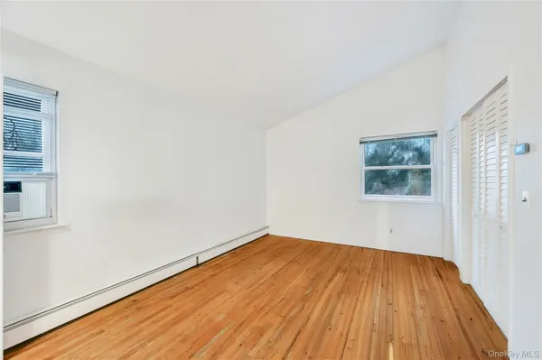 a view of a room with wooden floor and window