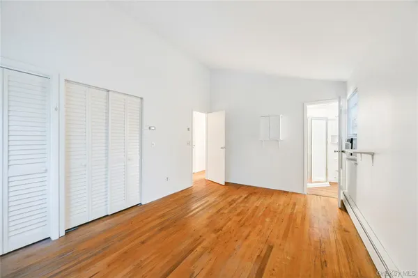 a view of a room with wooden floor