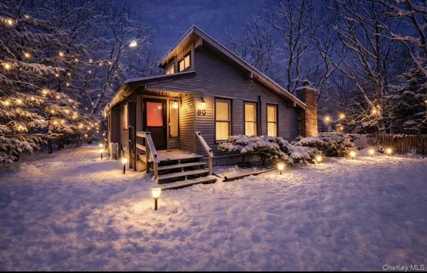 a backyard of a house with barbeque oven and trees