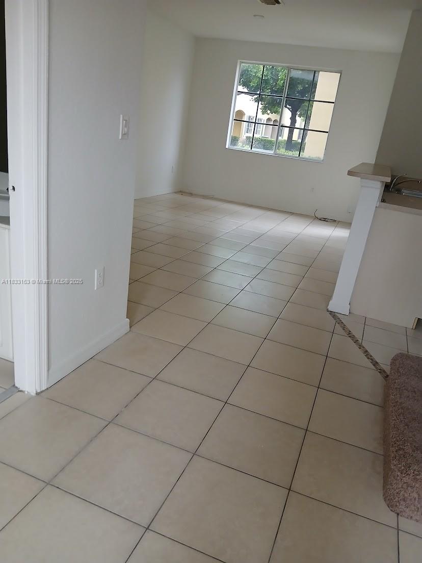 1909 Southwest 60th Avenue, Unit 1909 North Lauderdale, FL 33068 - Photo 2 of 19 an empty room with windows and fireplace