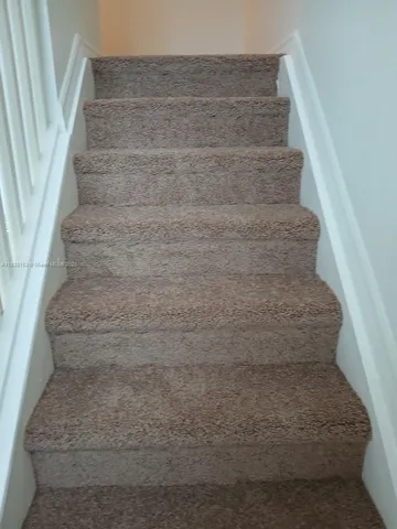 a view of staircase with white walls