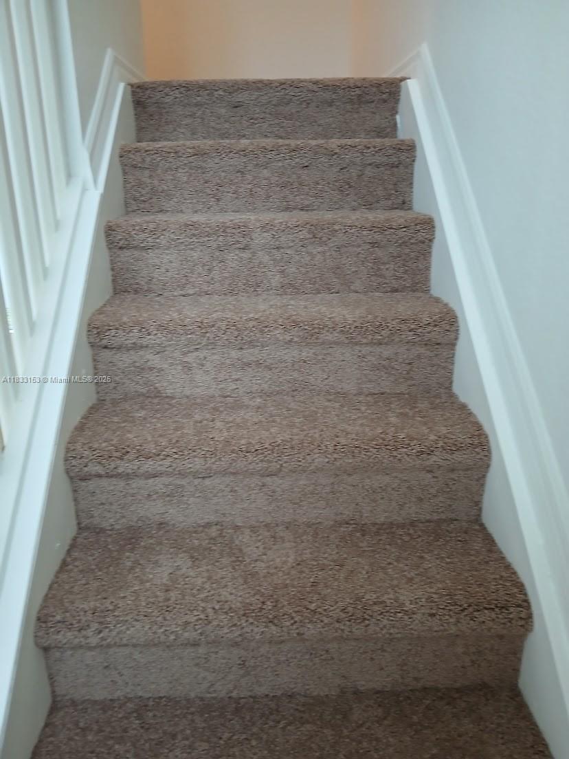 1909 Southwest 60th Avenue, Unit 1909 North Lauderdale, FL 33068 - Photo 4 of 19 a view of staircase with white walls