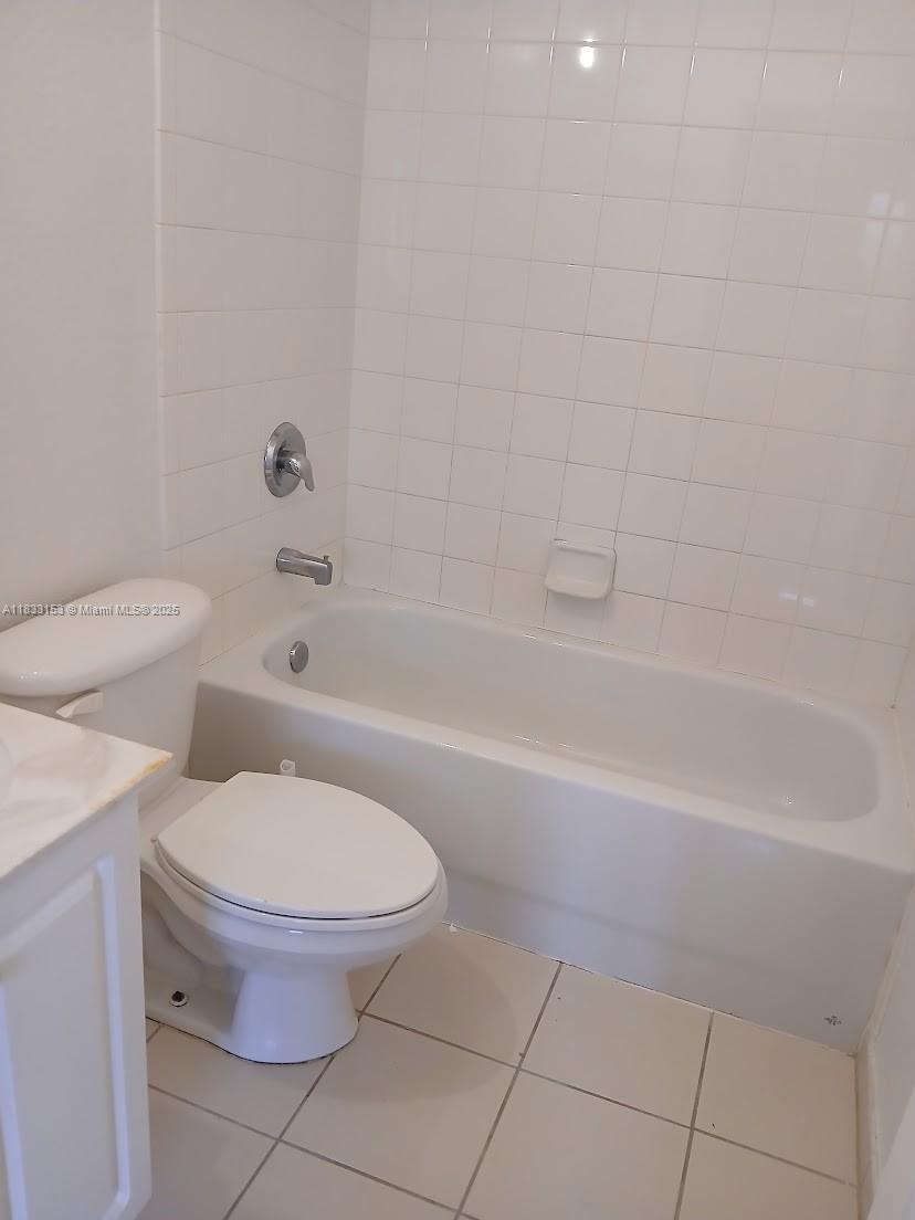 1909 Southwest 60th Avenue, Unit 1909 North Lauderdale, FL 33068 - Photo 10 of 19 a bathroom with a toilet and a bathtub