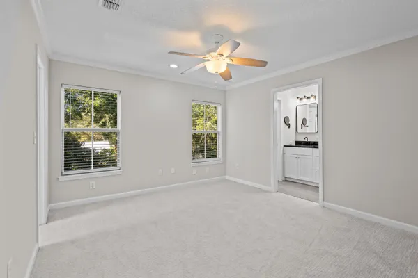 an empty room with windows and cabinet