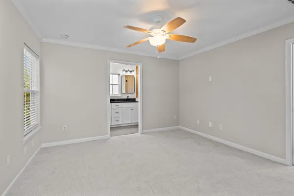 an empty room with closet and windows