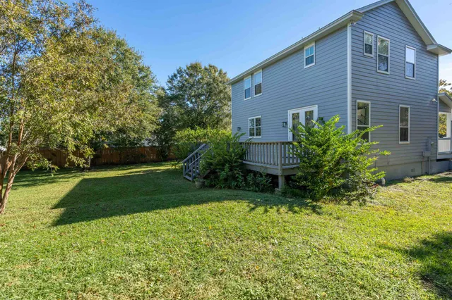 a view of a field with trees in the background