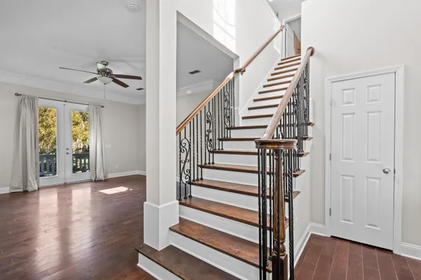 a view of entryway with wooden floor and stairs