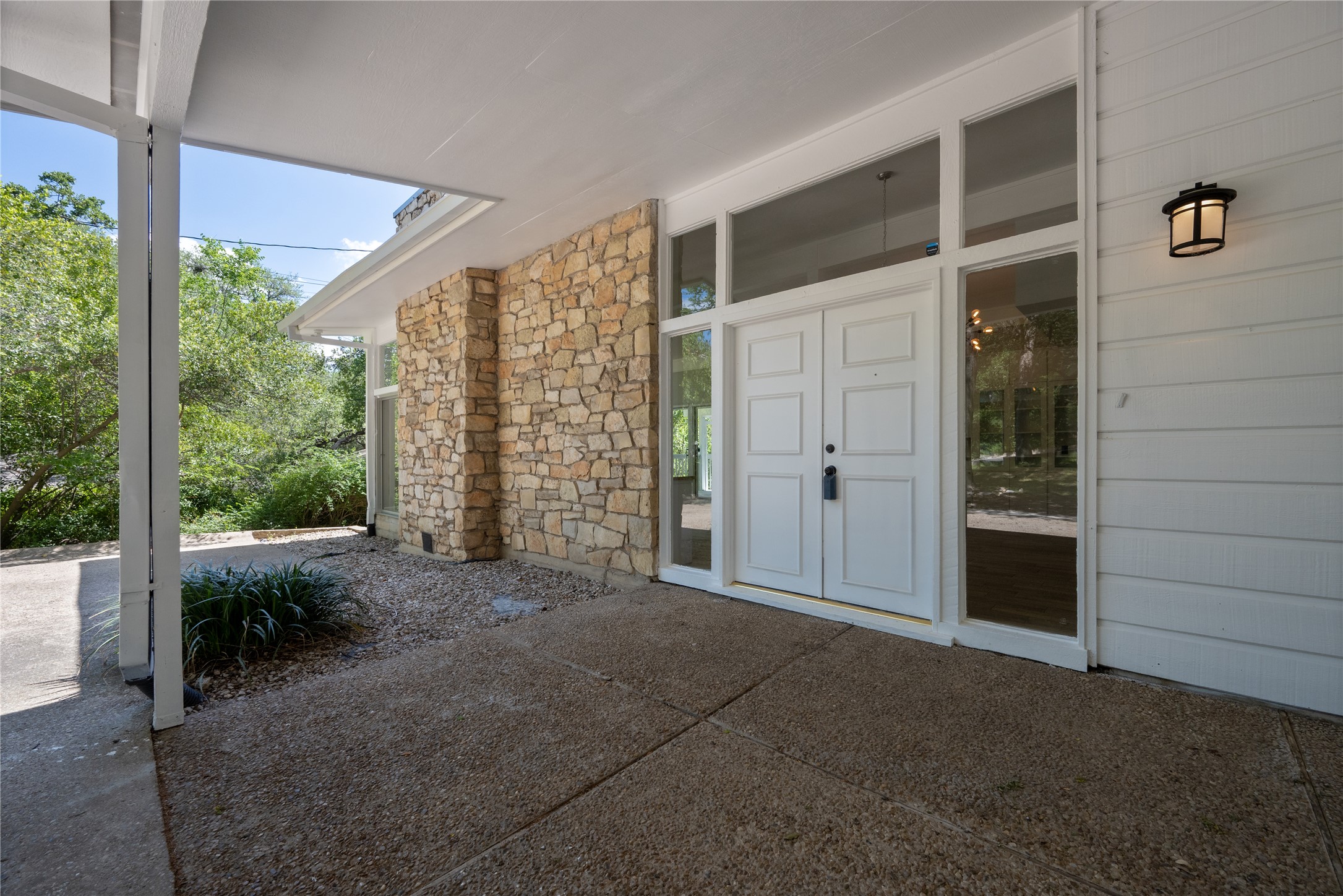 7 Hull Circle Austin, TX 78746 - Photo 3 of 17 A welcoming stone and siding facade with a covered entry and dual front doors.