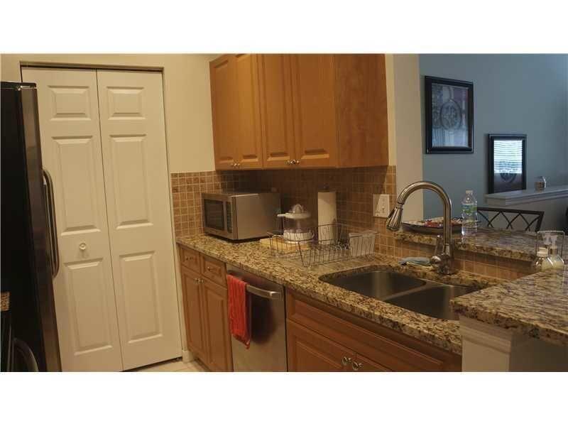 10312 Fox Trail Road South, Unit 1012 Royal Palm Beach, FL 33411 - Photo 3 of 6 a kitchen with a sink and cabinets