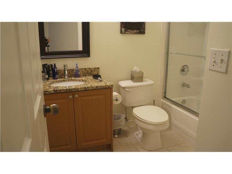 10312 Fox Trail Road South, Unit 1012 Royal Palm Beach, FL 33411 - Photo 4 of 6 a bathroom with a sink a toilet and shower