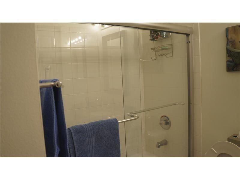 10312 Fox Trail Road South, Unit 1012 Royal Palm Beach, FL 33411 - Photo 5 of 6 a bathroom with a sink a shower a mirror and a bathtub