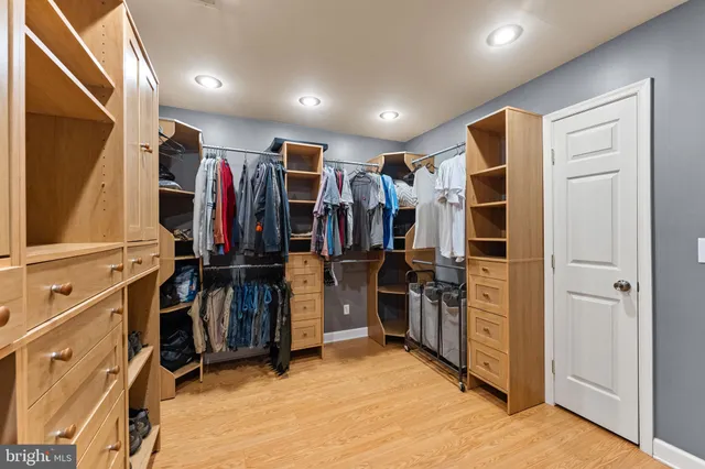 a view of walk in closet with clothes