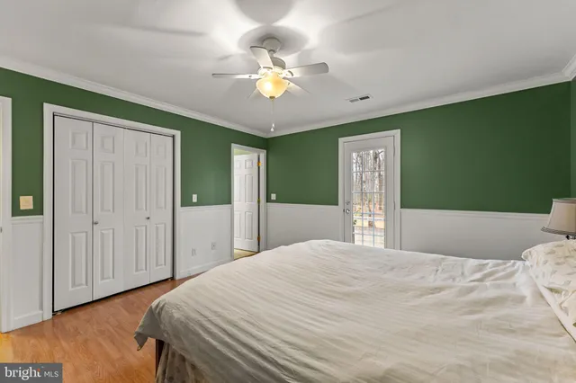 a bedroom with a large bed and chandelier