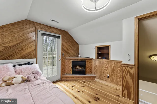 a bedroom with a bed and a fireplace