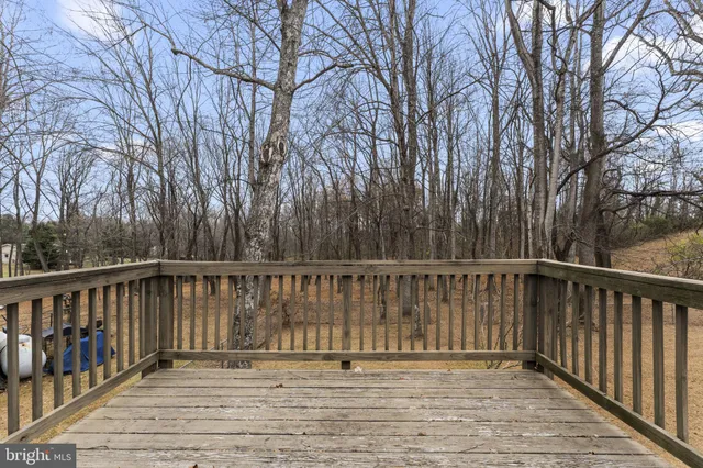 a balcony with wooden floor and fence