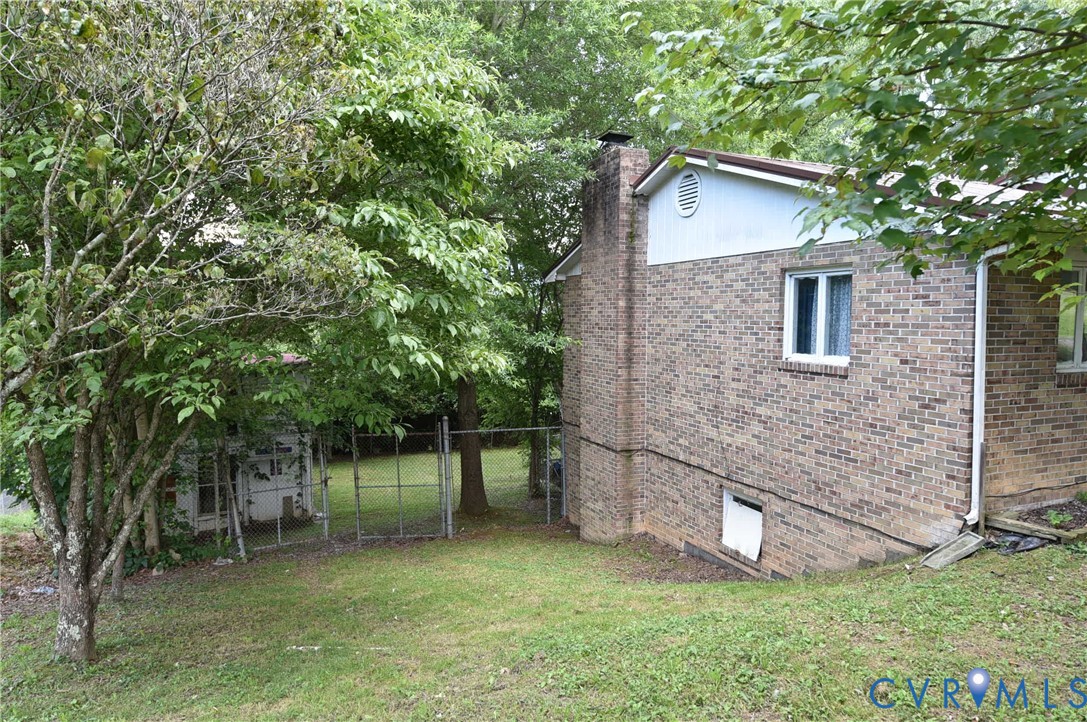 642 Star Street Pounding Mill, VA 24637 - Photo 4 of 20 Brick exterior featuring a prominent chimney, whit