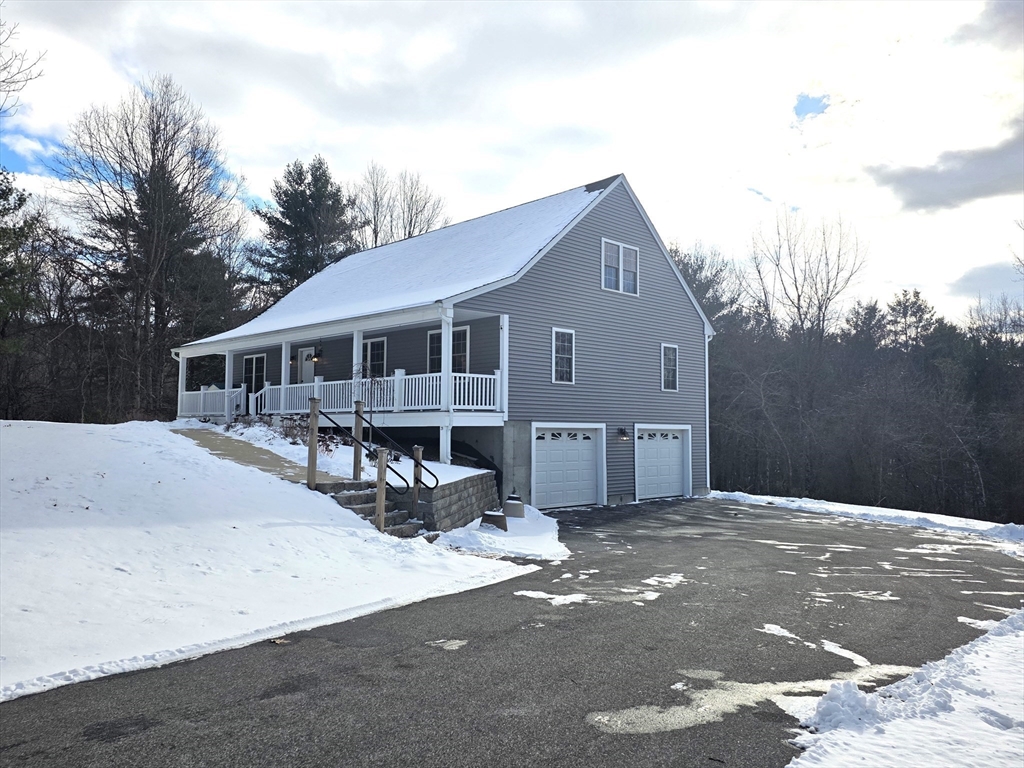 29 Lake Road Brookfield, MA 01506 - Photo 34 of 36 a view of a white house with a large space and a yard