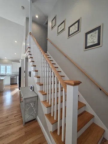 a view of entryway and hall with wooden floor
