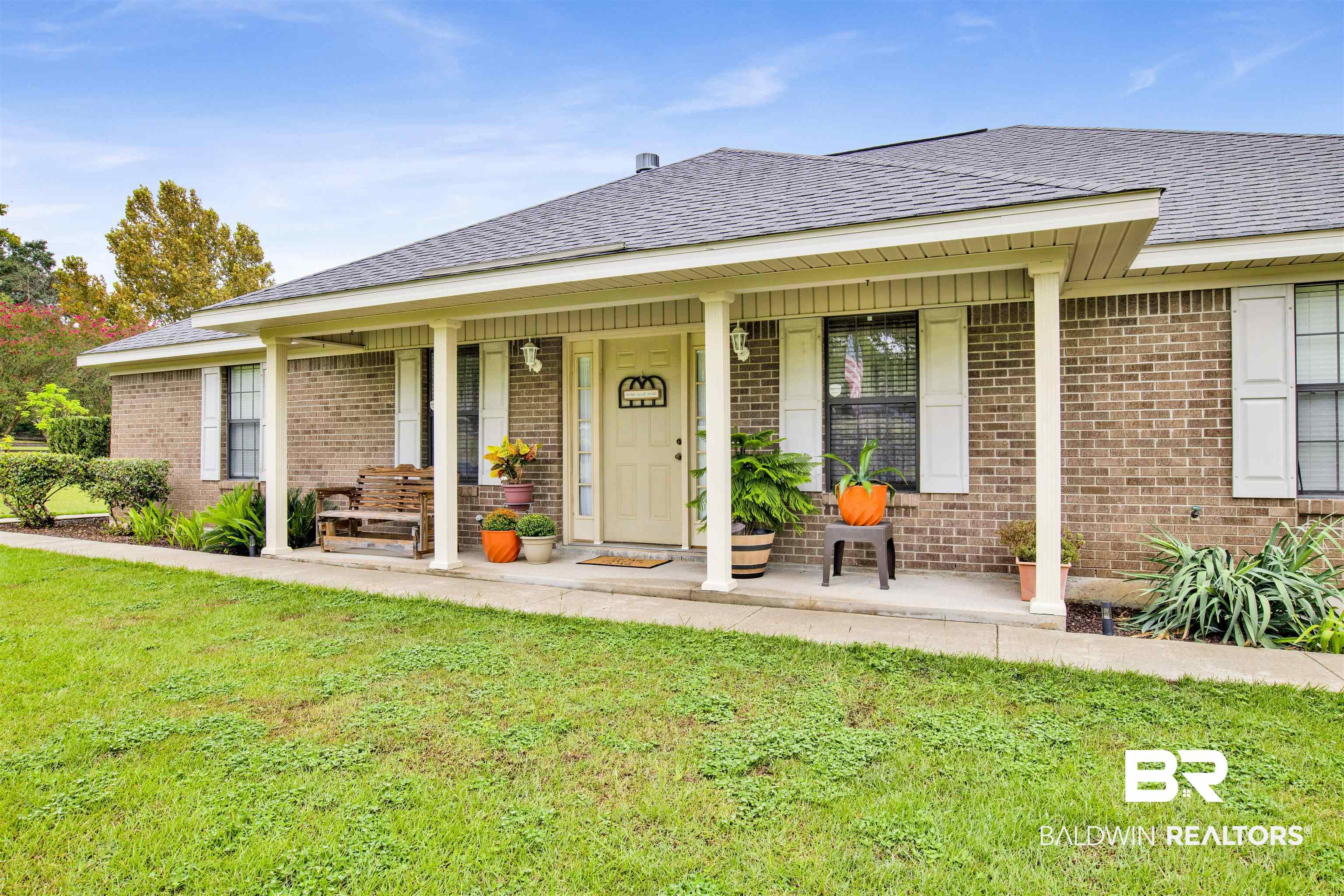 54563 Splinter Hill Road Perdido, AL 36562 - Photo 5 of 29 View of front of house featuring a porch and a front lawn