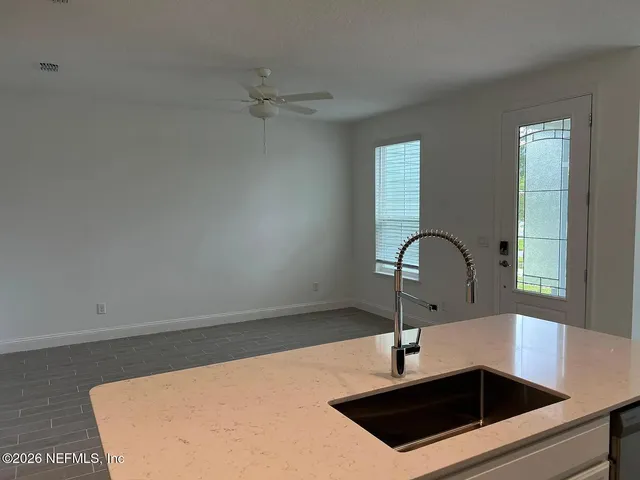 a kitchen with stainless steel appliances a refrigerator sink and white cabinets