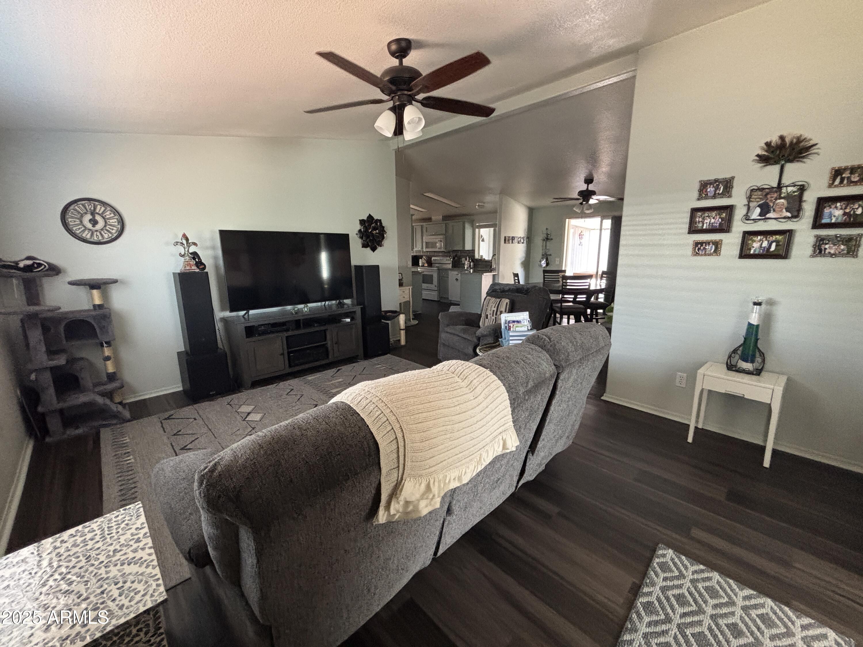 2400 East Baseline Avenue, Unit 80 Apache Junction, AZ 85119 - Photo 13 of 33 a living room with furniture and a flat screen tv