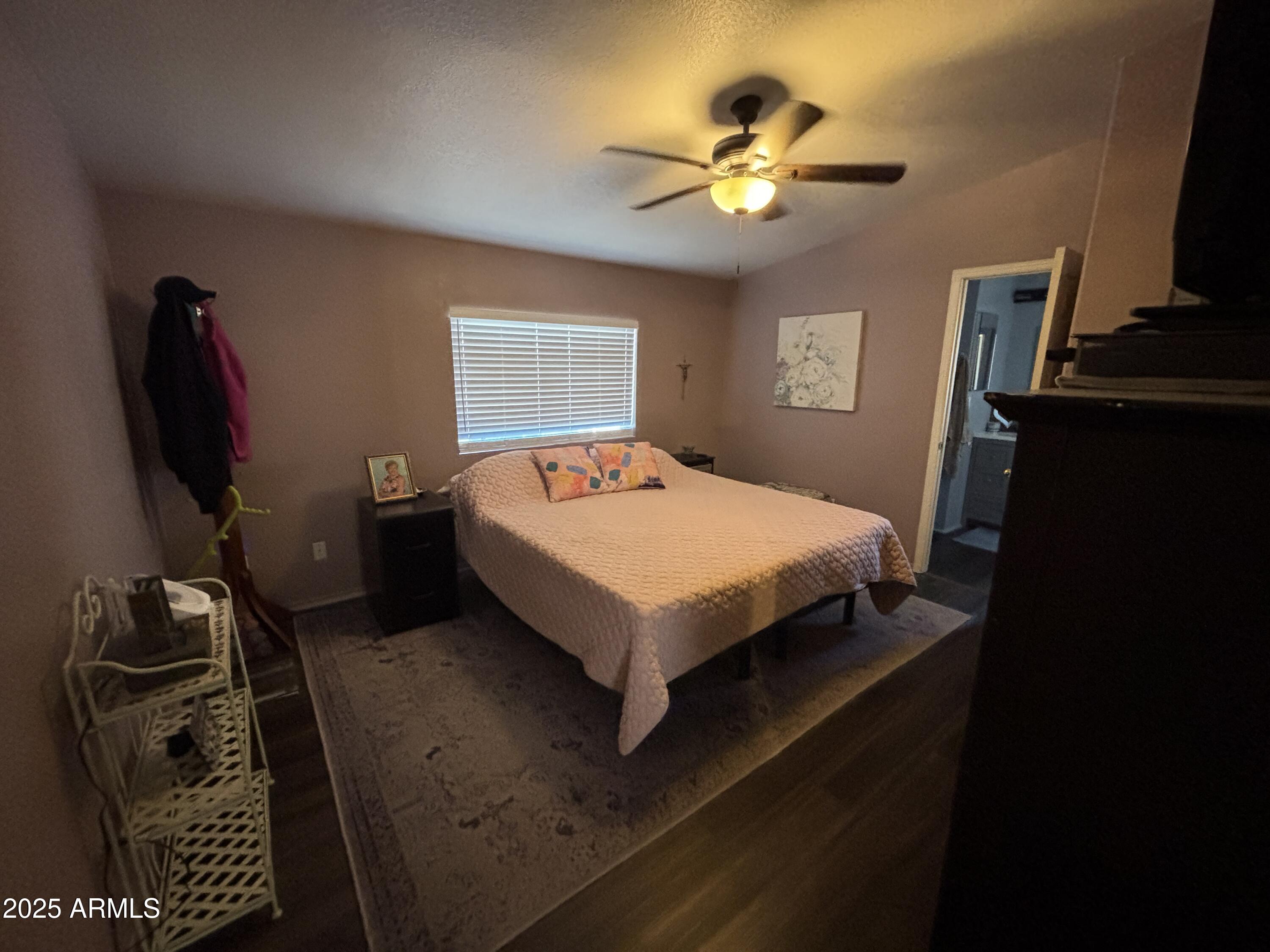 2400 East Baseline Avenue, Unit 80 Apache Junction, AZ 85119 - Photo 14 of 33 a bedroom with a bed and a flat screen tv