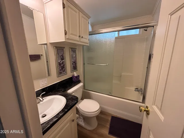 a bathroom with a toilet a sink and a shower