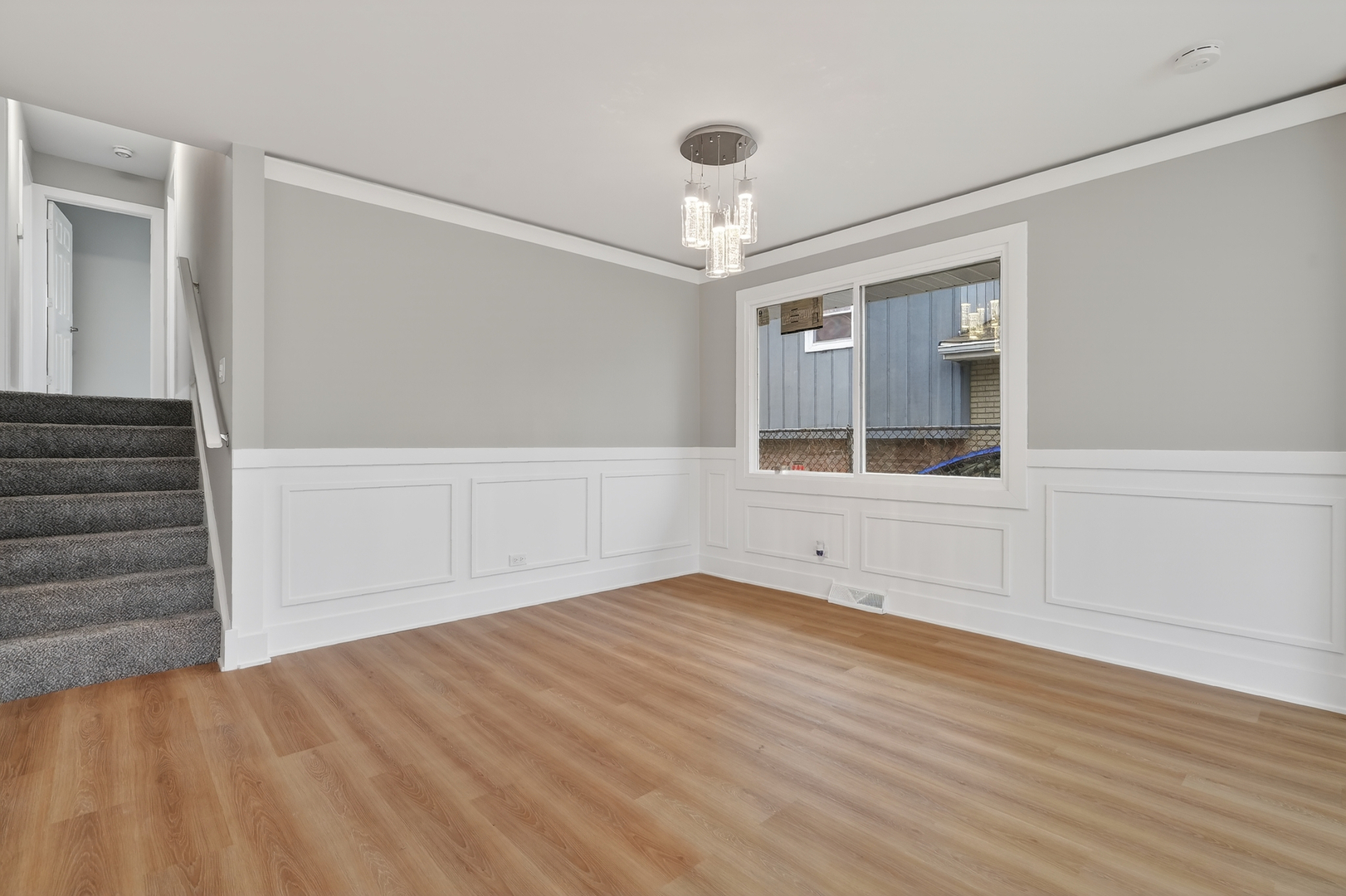 515 West 146th Street Dolton, IL 60419 - Photo 13 of 47 a view of an empty room with wooden floor and a window