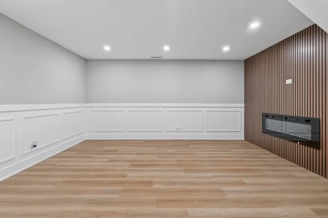 a view of an empty room with a fireplace